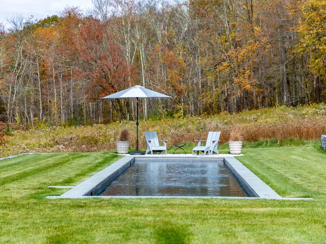 a view of a backyard with swimming pool