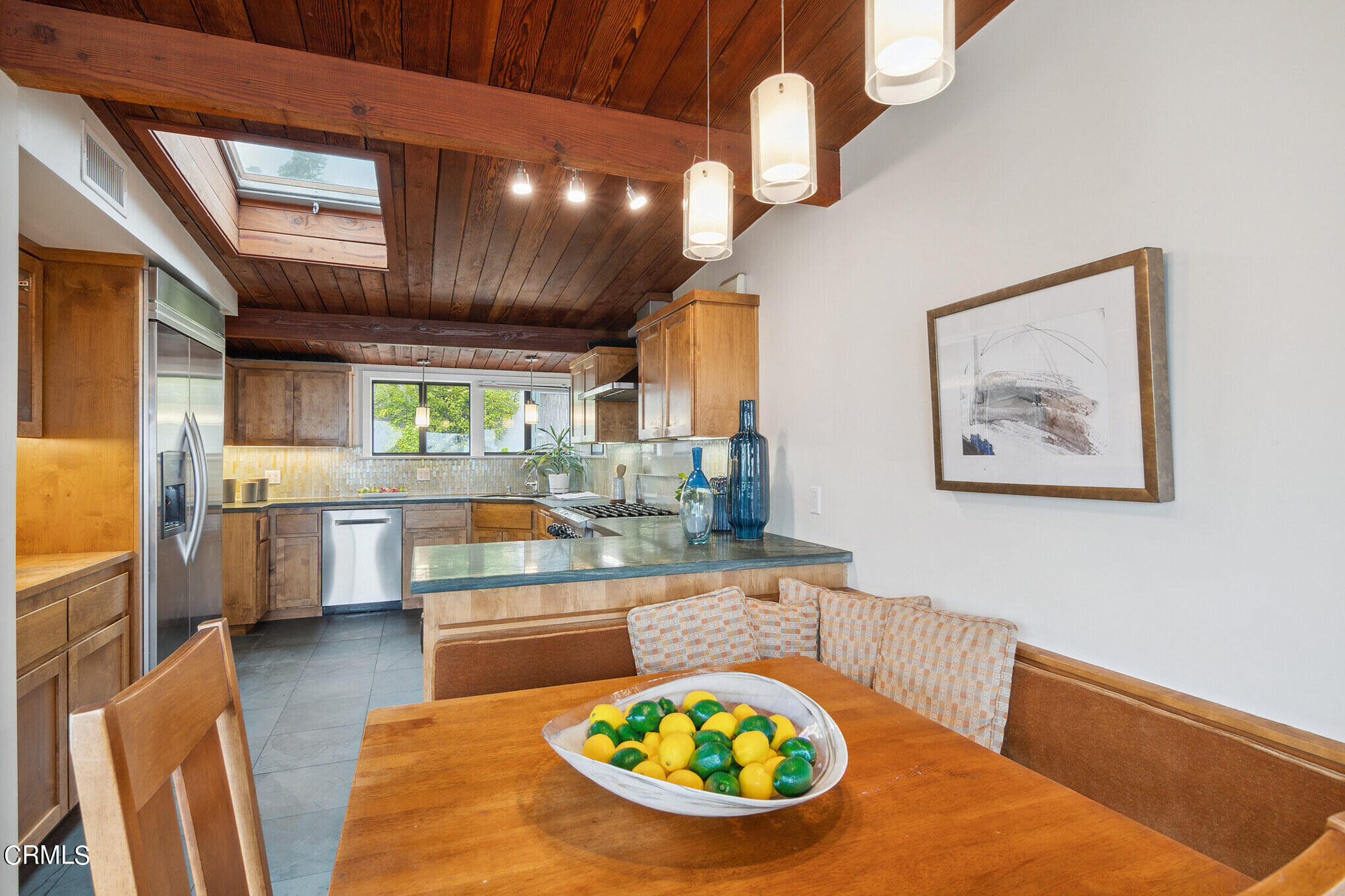 4554 Rising Hill Road Altadena, CA 91001 - Photo 16 of 56 a kitchen with stainless steel appliances granite countertop a sink a stove top oven a dining table and chairs with wooden floor