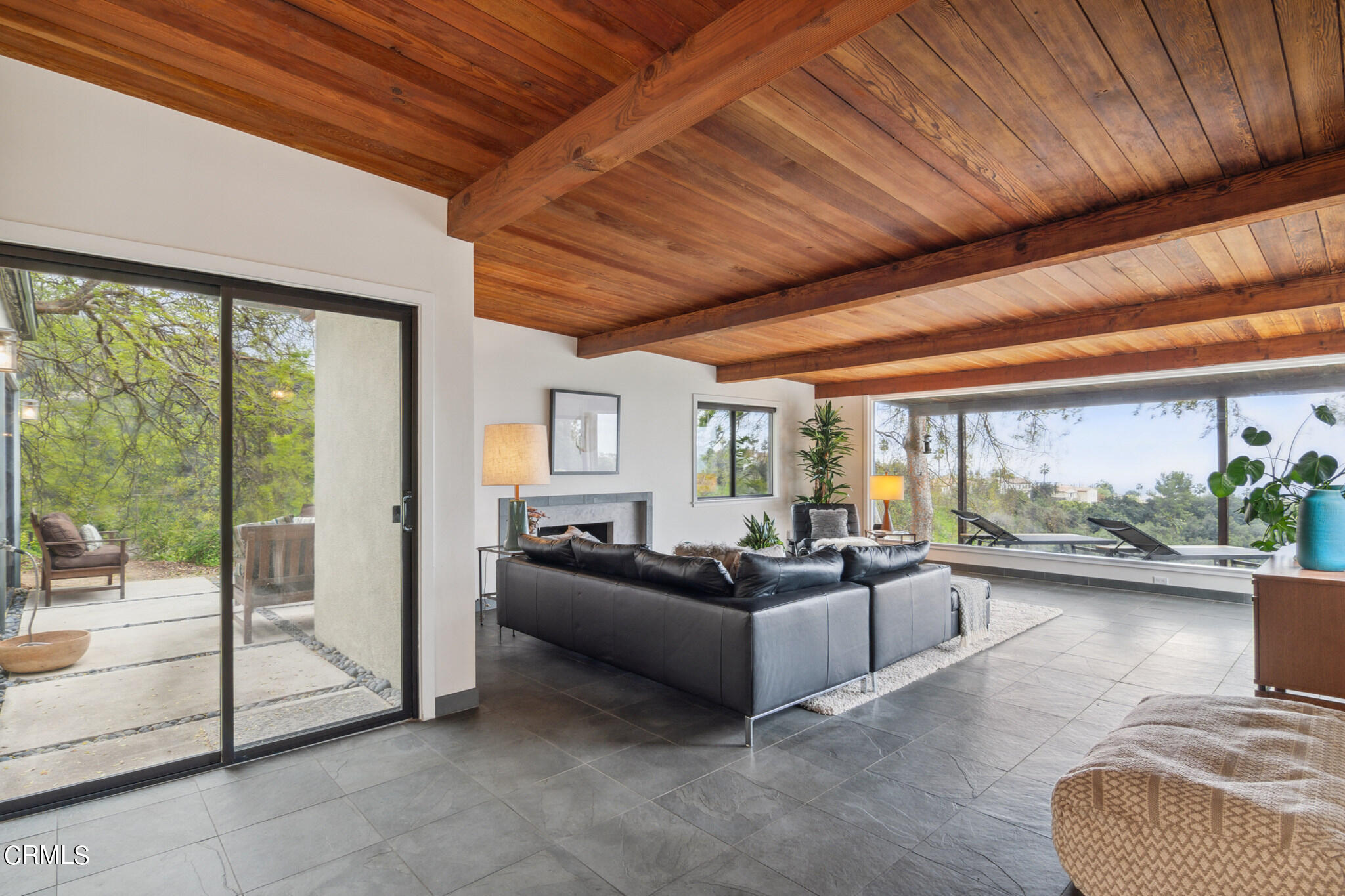 4554 Rising Hill Road Altadena, CA 91001 - Photo 21 of 56 a living room with furniture large windows and a rug