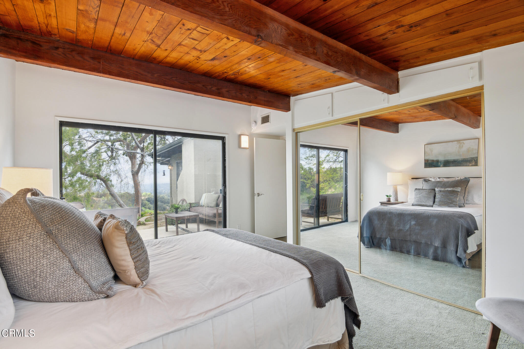 4554 Rising Hill Road Altadena, CA 91001 - Photo 28 of 56 a bedroom with a large bed and a large window