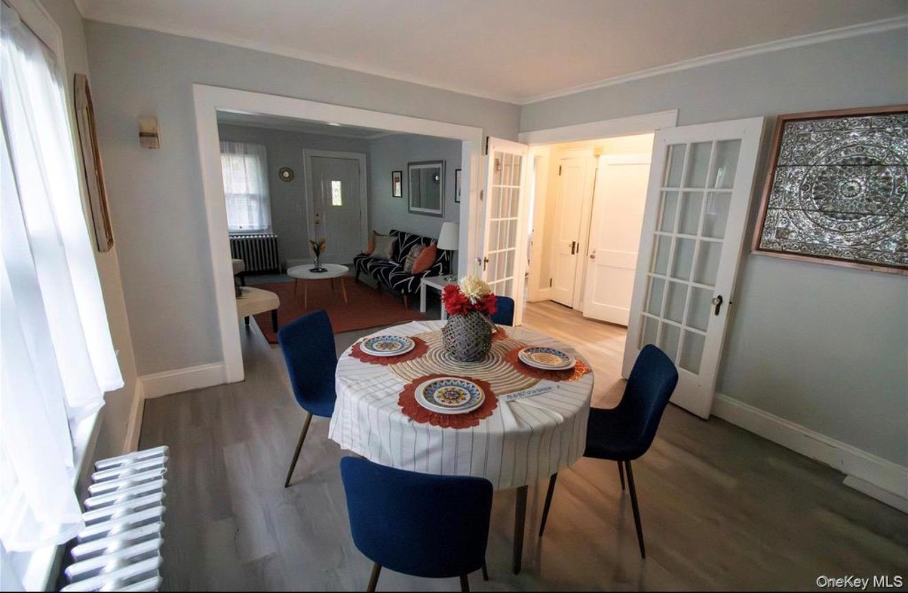 76 Henry Street Roosevelt, NY 11575 - Photo 4 of 14 a view of a dining room with furniture and wooden floor