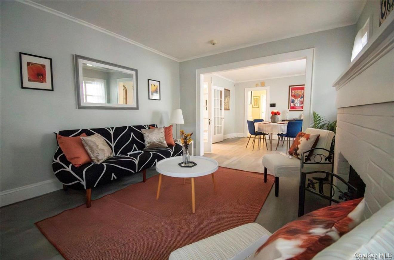 76 Henry Street Roosevelt, NY 11575 - Photo 14 of 14 a living room with furniture and a wooden floor