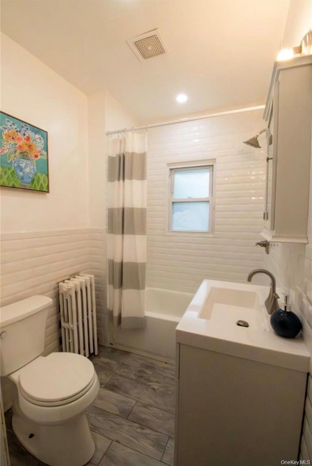 76 Henry Street Roosevelt, NY 11575 - Photo 6 of 14 a bathroom with a toilet and a sink