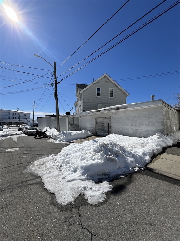 1768 Pleasant Street Fall River, MA 02723 - Photo 4 of 10 a bed sitting in a bedroom next to a lamp