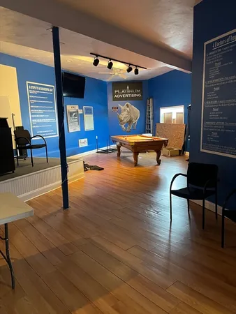 a living room with furniture window and wooden floor
