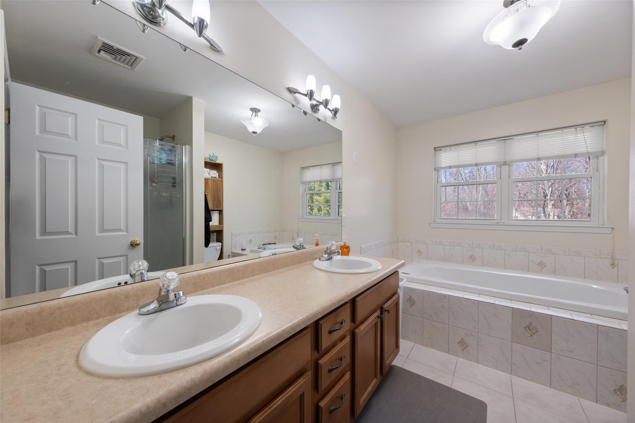 15 Bobrick Road Poughkeepsie, NY 12601 - Photo 16 of 36 Bathroom featuring a sink, visible vents, tile patterned floors, and a garden tub