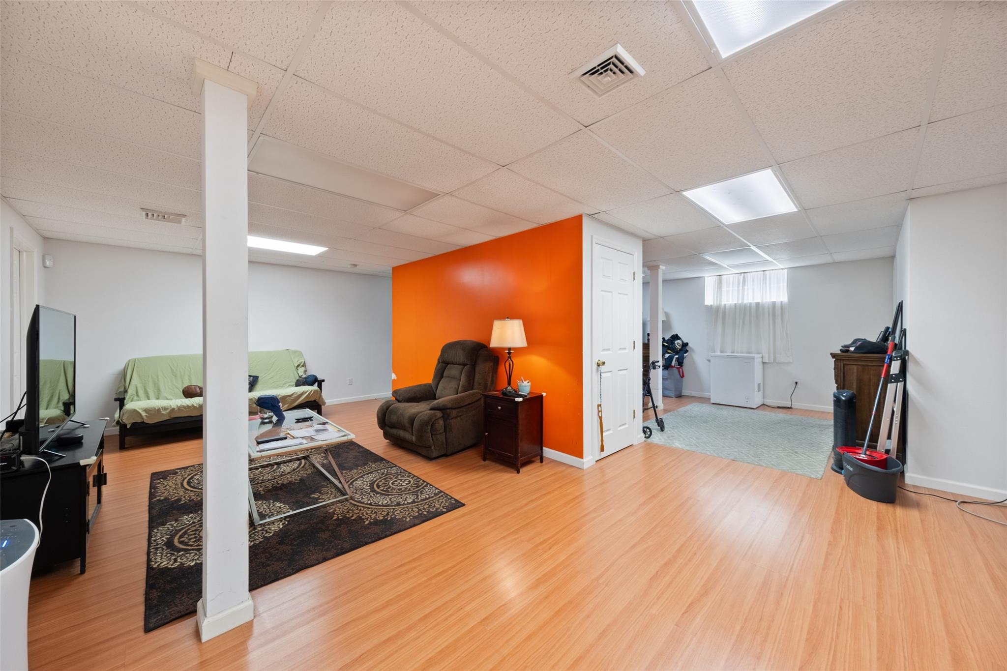 15 Bobrick Road Poughkeepsie, NY 12601 - Photo 26 of 36 Living area featuring visible vents, baseboards, a paneled ceiling, and wood finished floors
