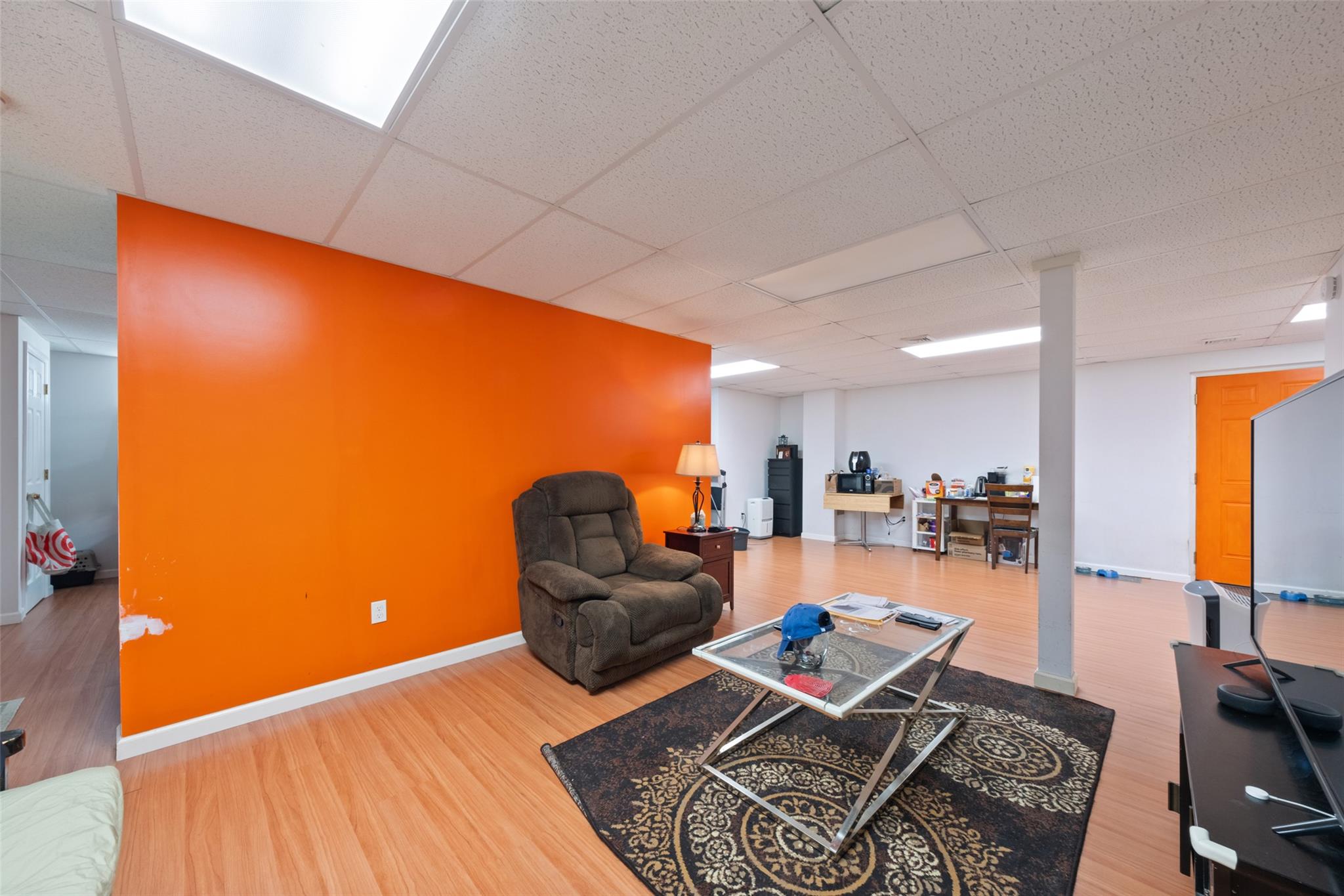 15 Bobrick Road Poughkeepsie, NY 12601 - Photo 27 of 36 Living area featuring a drop ceiling, baseboards, and wood finished floors
