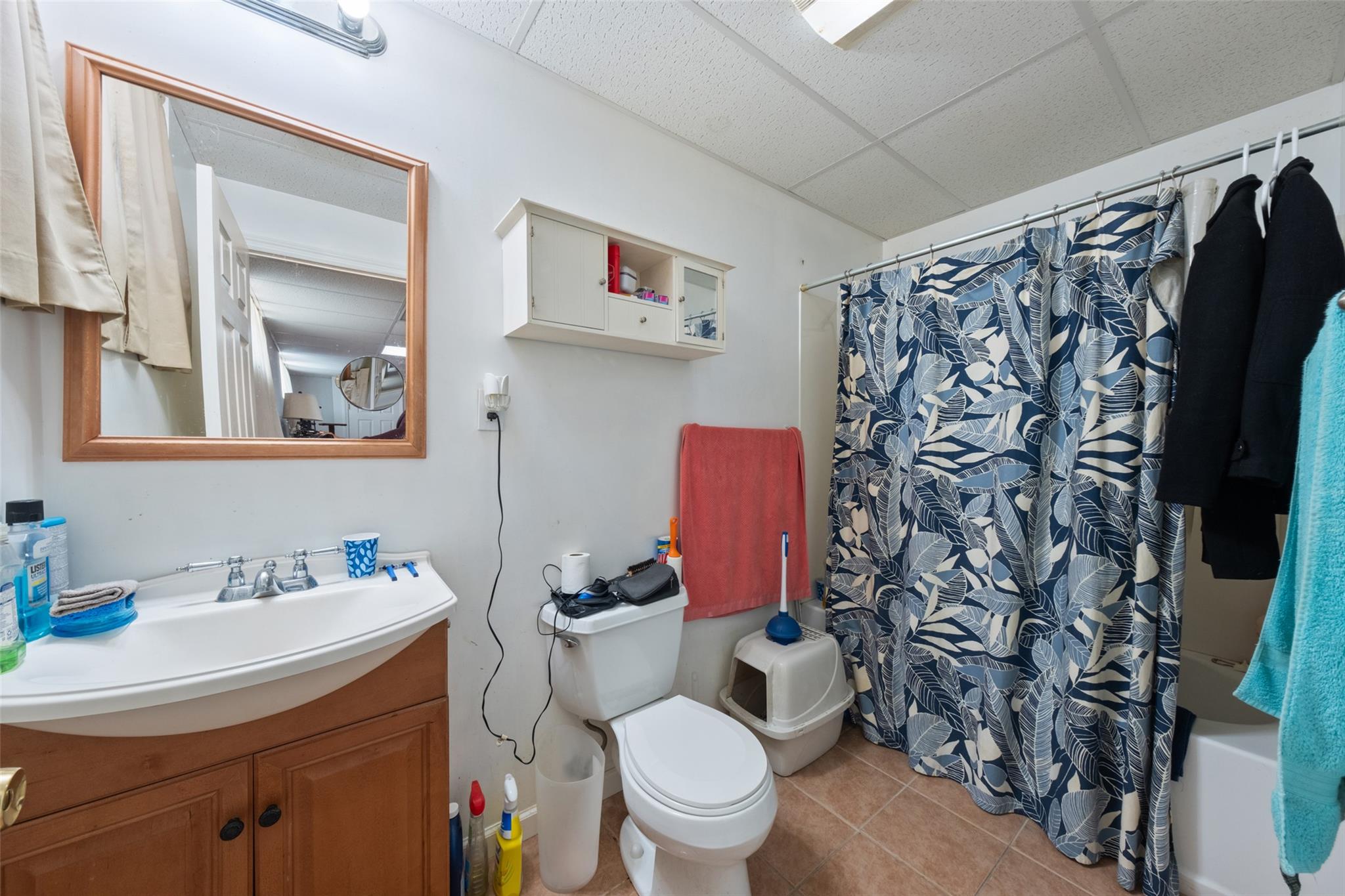 15 Bobrick Road Poughkeepsie, NY 12601 - Photo 28 of 36 Full bathroom with toilet, a paneled ceiling, shower / bathtub combination with curtain, vanity, and tile patterned flooring