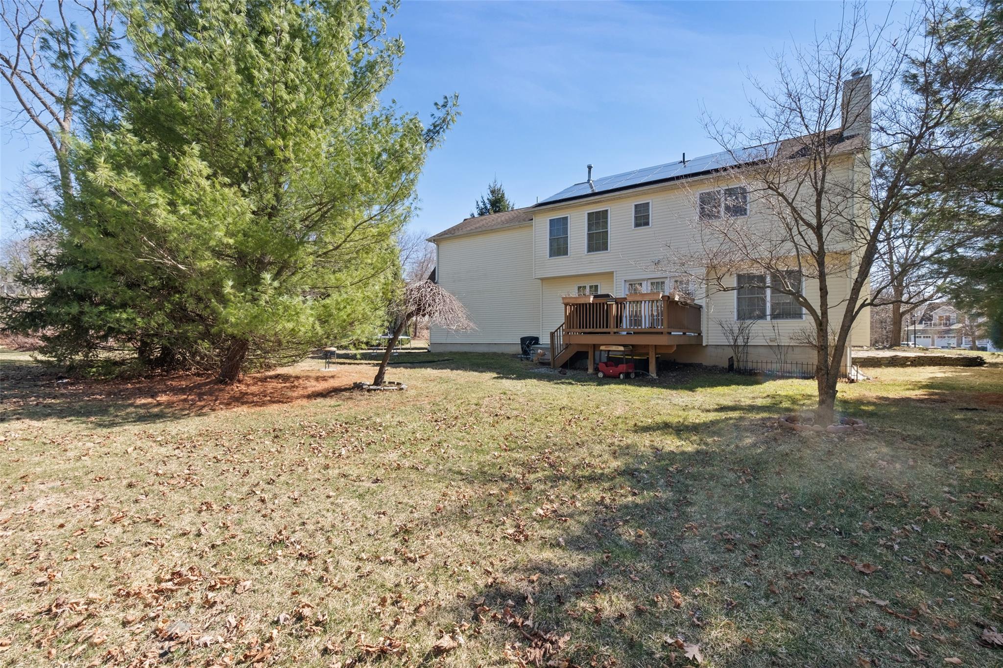 15 Bobrick Road Poughkeepsie, NY 12601 - Photo 31 of 36 Back of house featuring a yard, a wooden deck, solar panels, and a chimney