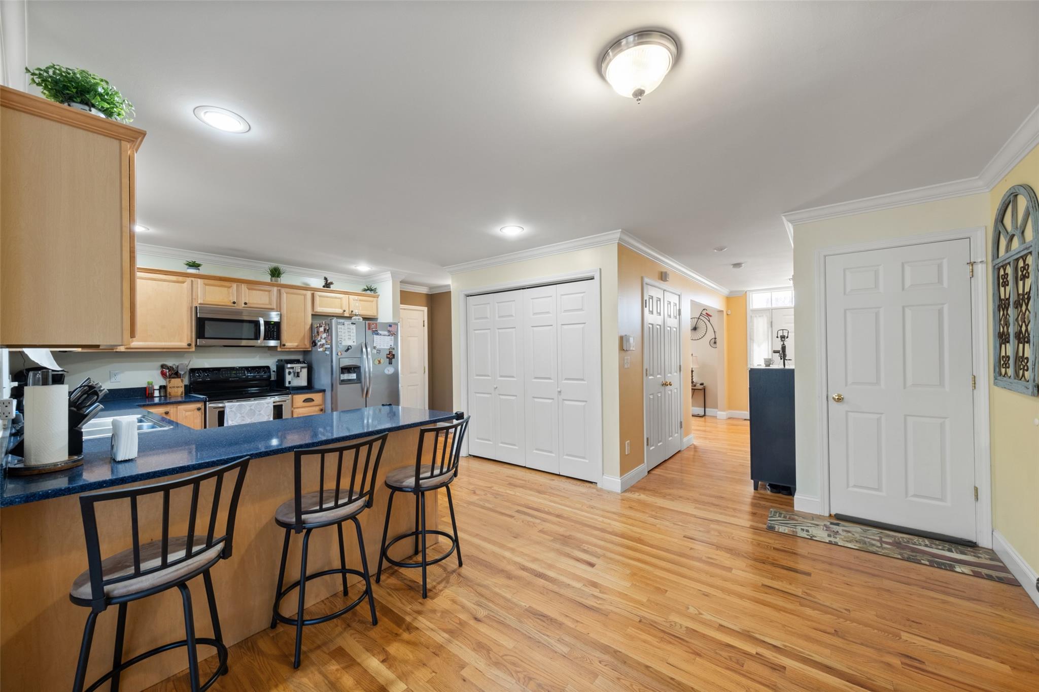 15 Bobrick Road Poughkeepsie, NY 12601 - Photo 6 of 36 Kitchen with light brown cabinetry, dark countertops, a peninsula, and stainless steel appliances