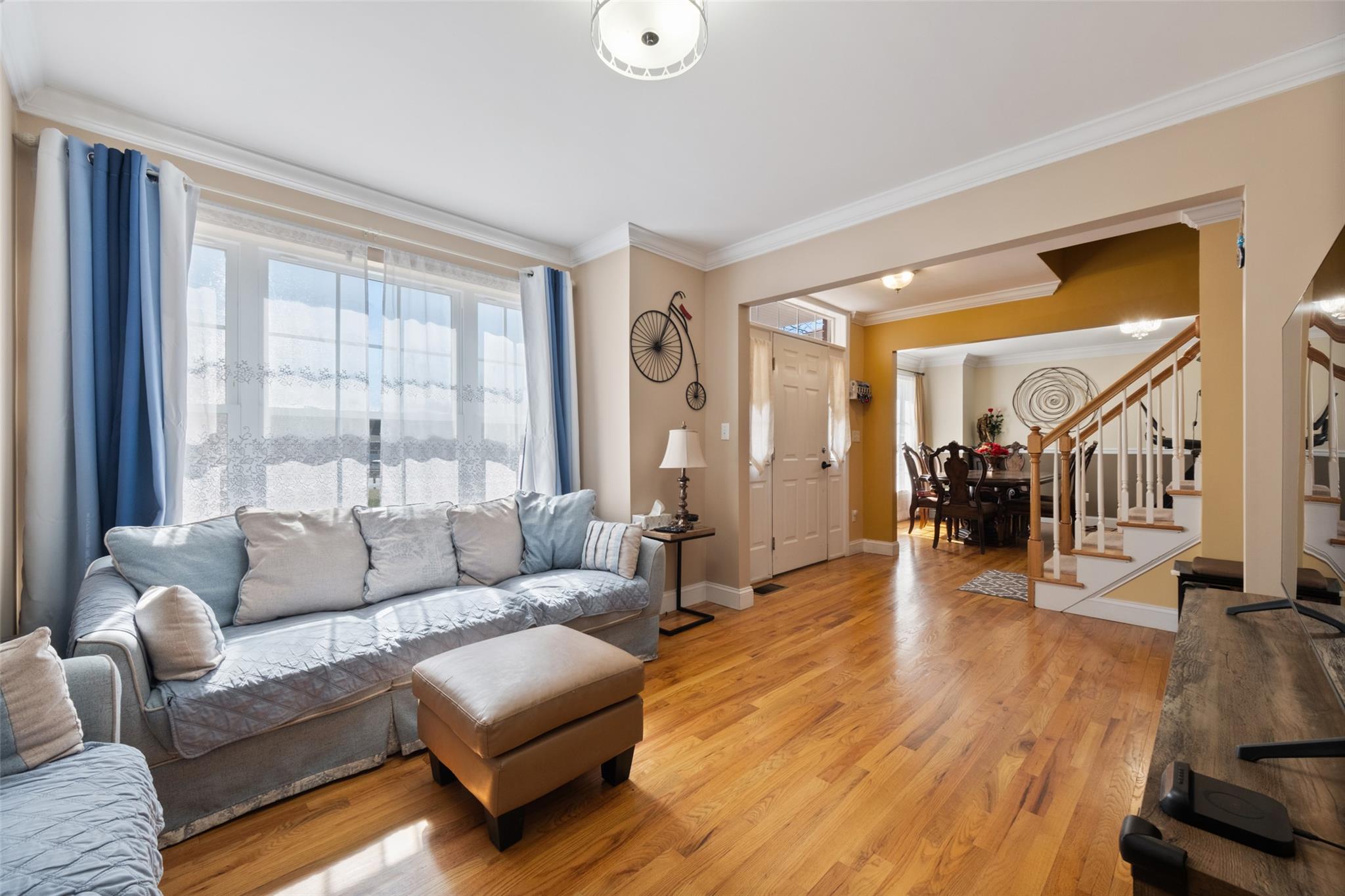 15 Bobrick Road Poughkeepsie, NY 12601 - Photo 8 of 36 Living area with baseboards, stairway, light wood-type flooring, and crown molding
