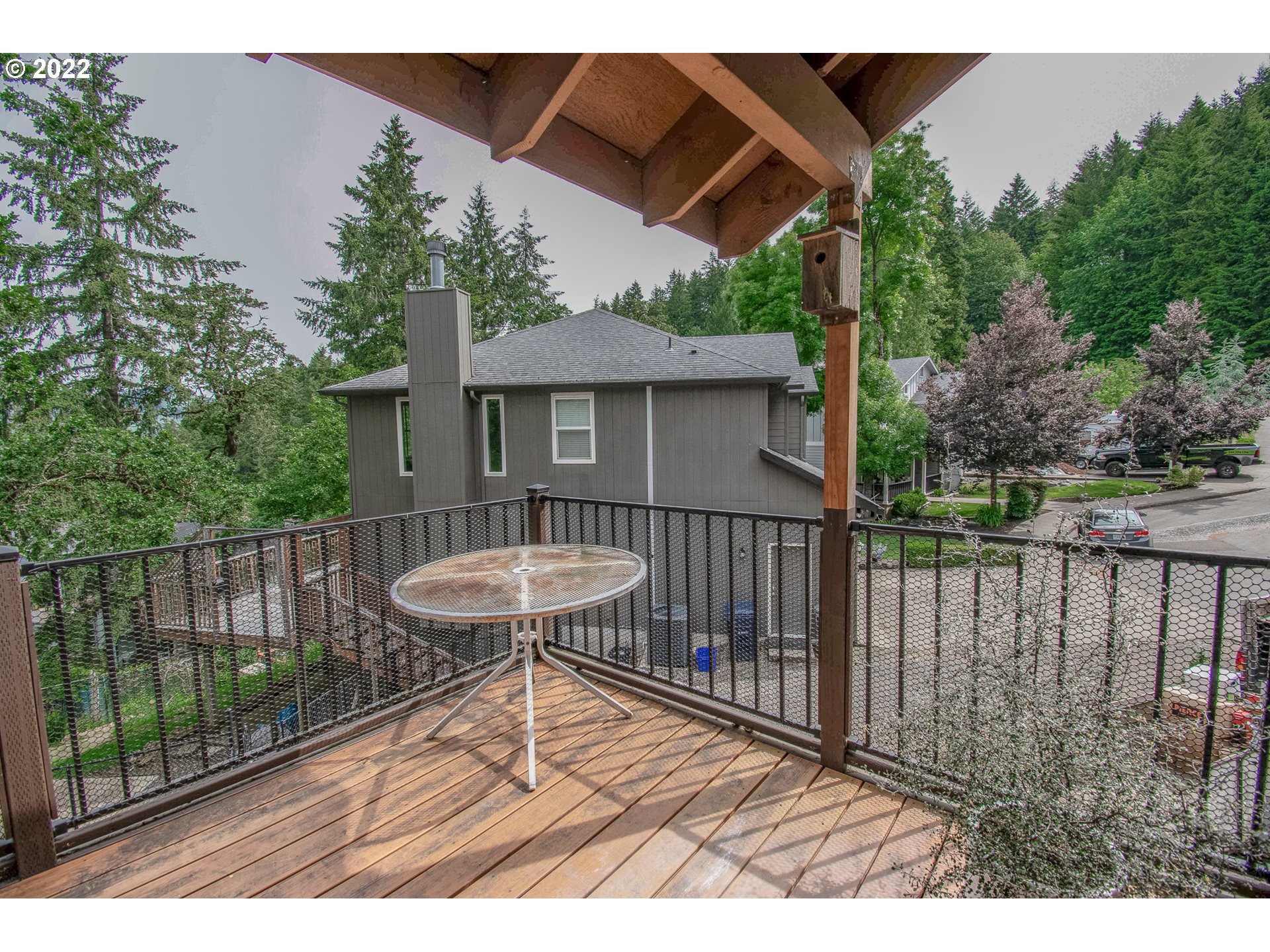 864 South 73rd Street Springfield, OR 97478 - Photo 9 of 30 a view of a deck with a table and chairs under an umbrella with wooden fence