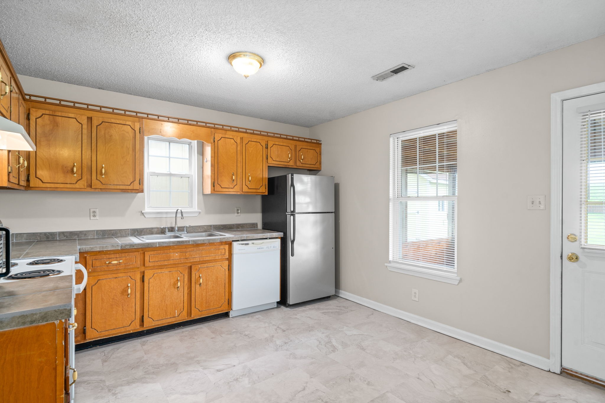 241 Bumpus Mill Road Oak Grove, KY 42262 - Photo 12 of 31 a kitchen with stainless steel appliances granite countertop a refrigerator sink and cabinets