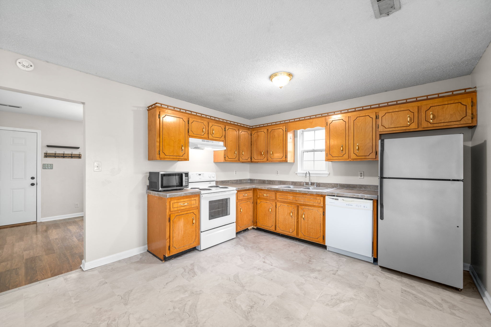 241 Bumpus Mill Road Oak Grove, KY 42262 - Photo 13 of 31 a kitchen with stainless steel appliances granite countertop a refrigerator a sink and a stove