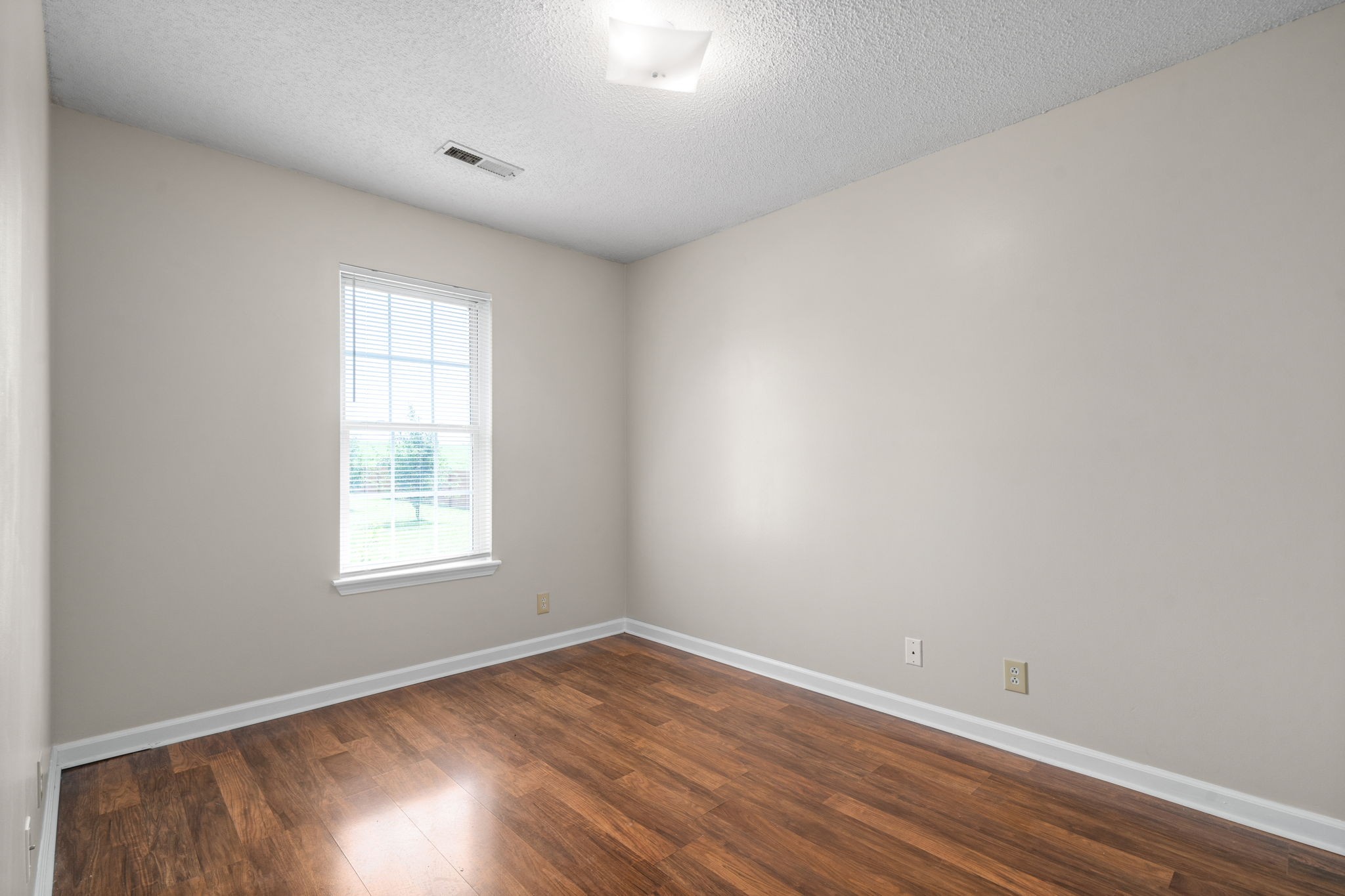 241 Bumpus Mill Road Oak Grove, KY 42262 - Photo 20 of 31 an empty room with wooden floor and windows