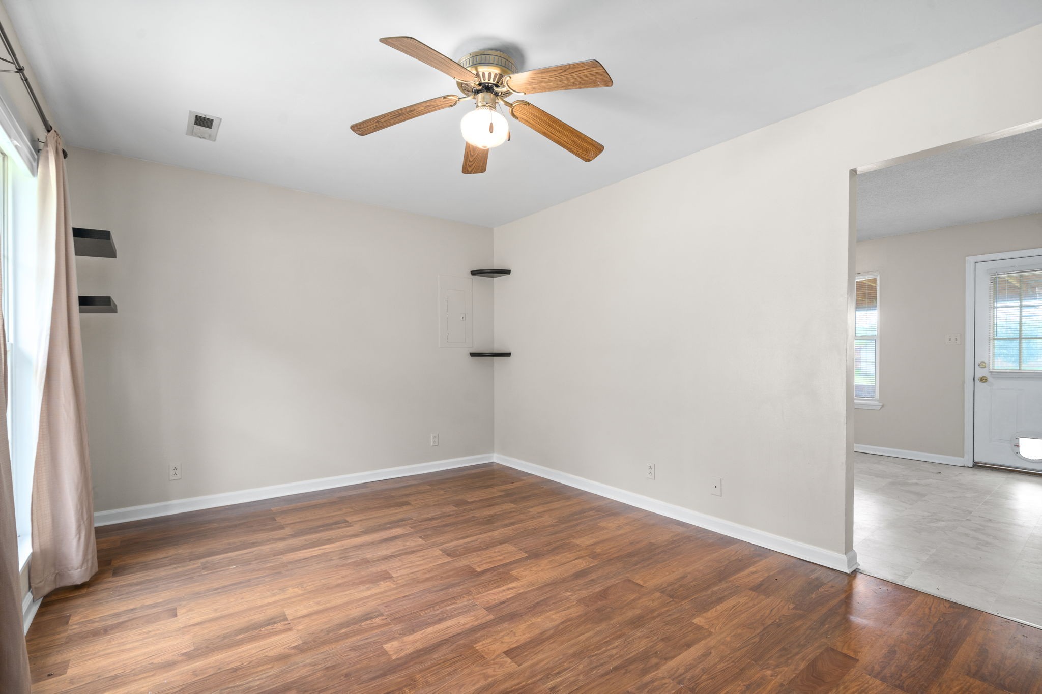 241 Bumpus Mill Road Oak Grove, KY 42262 - Photo 8 of 31 an empty room with wooden floor and fan