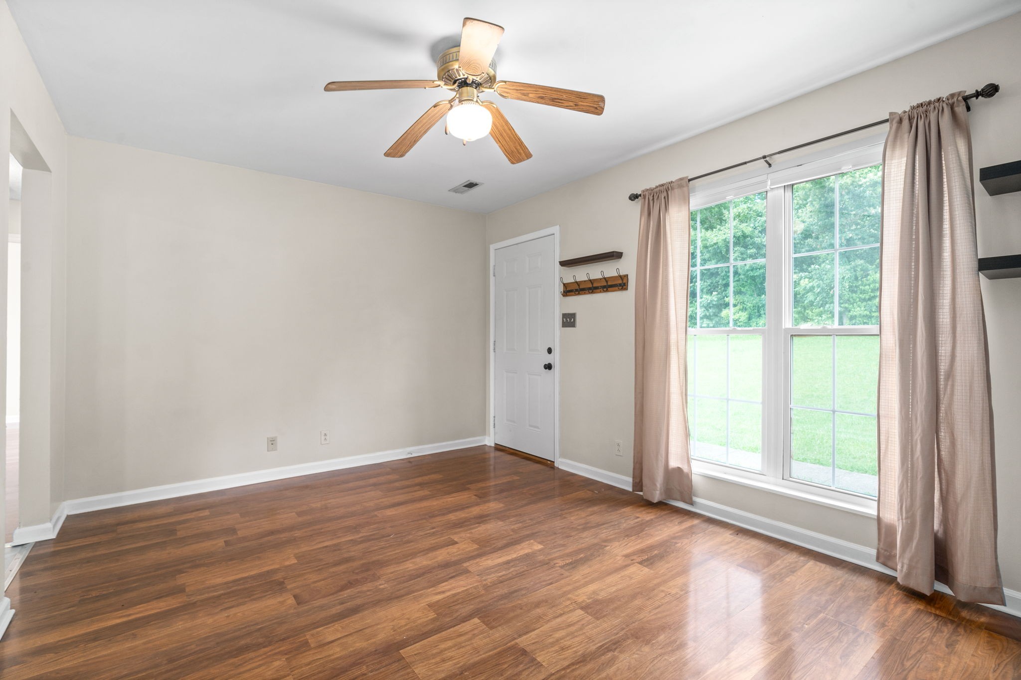 241 Bumpus Mill Road Oak Grove, KY 42262 - Photo 10 of 31 an empty room with wooden floor fan and windows