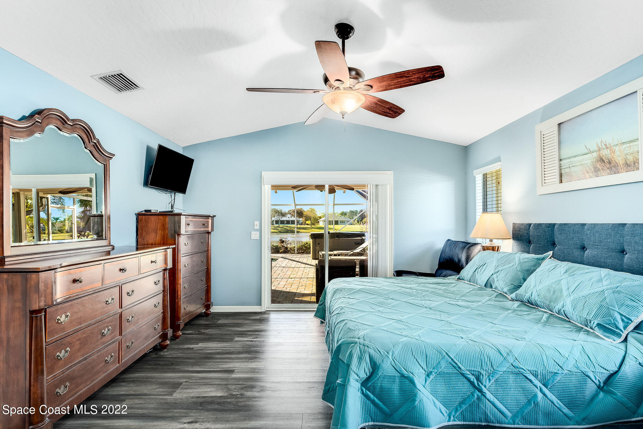 1566 Eagles Circle Sebastian, FL 32958 - Photo 32 of 59 a bedroom with a bed and a flat screen tv with dresser