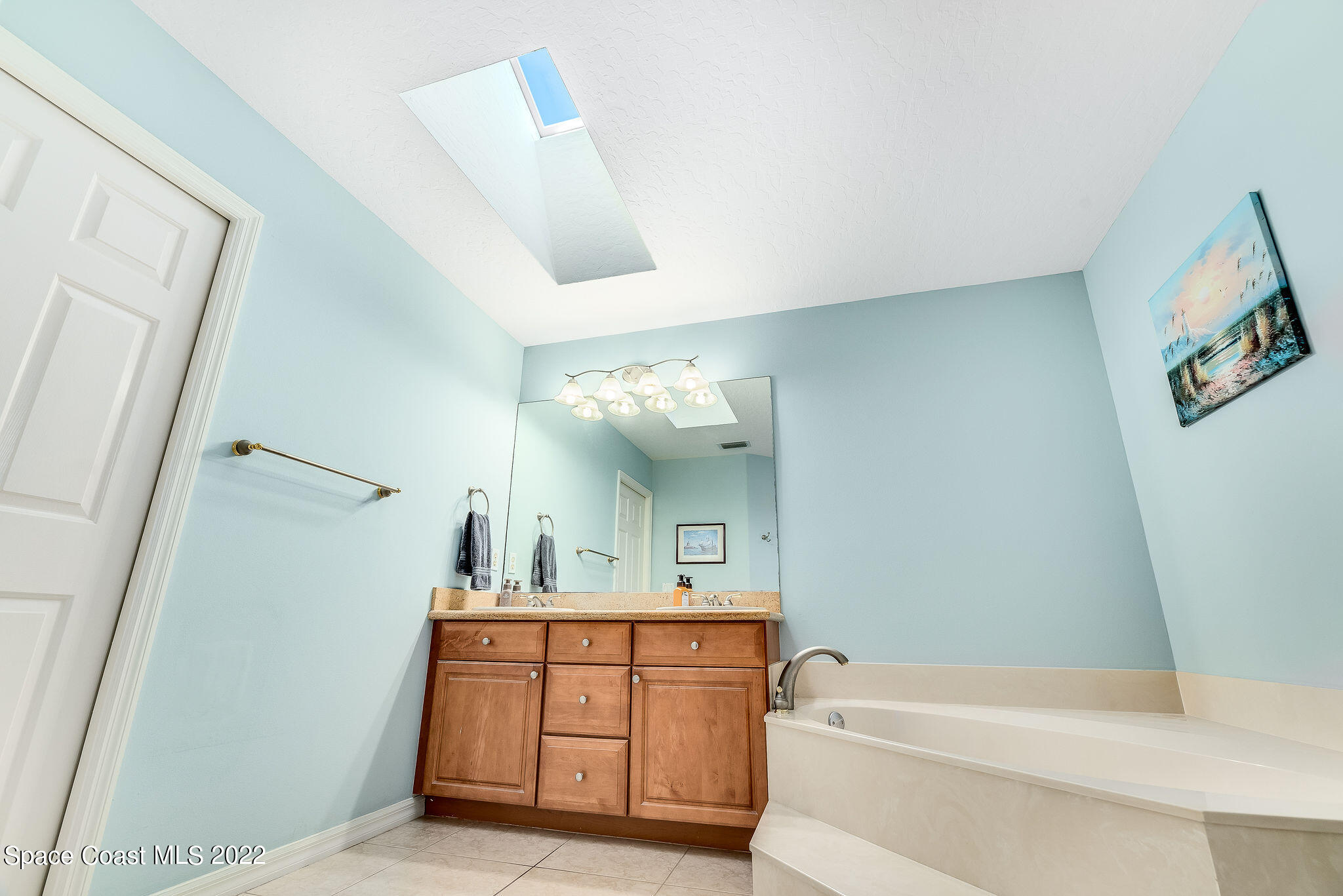 1566 Eagles Circle Sebastian, FL 32958 - Photo 36 of 59 a bathroom with a tub sink and mirror