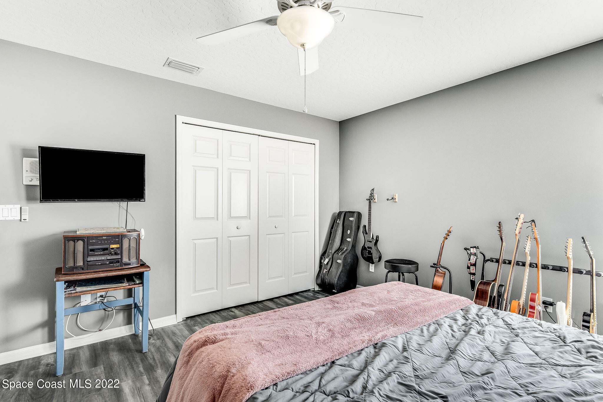 1566 Eagles Circle Sebastian, FL 32958 - Photo 39 of 59 a bedroom with a bed and a flat screen tv