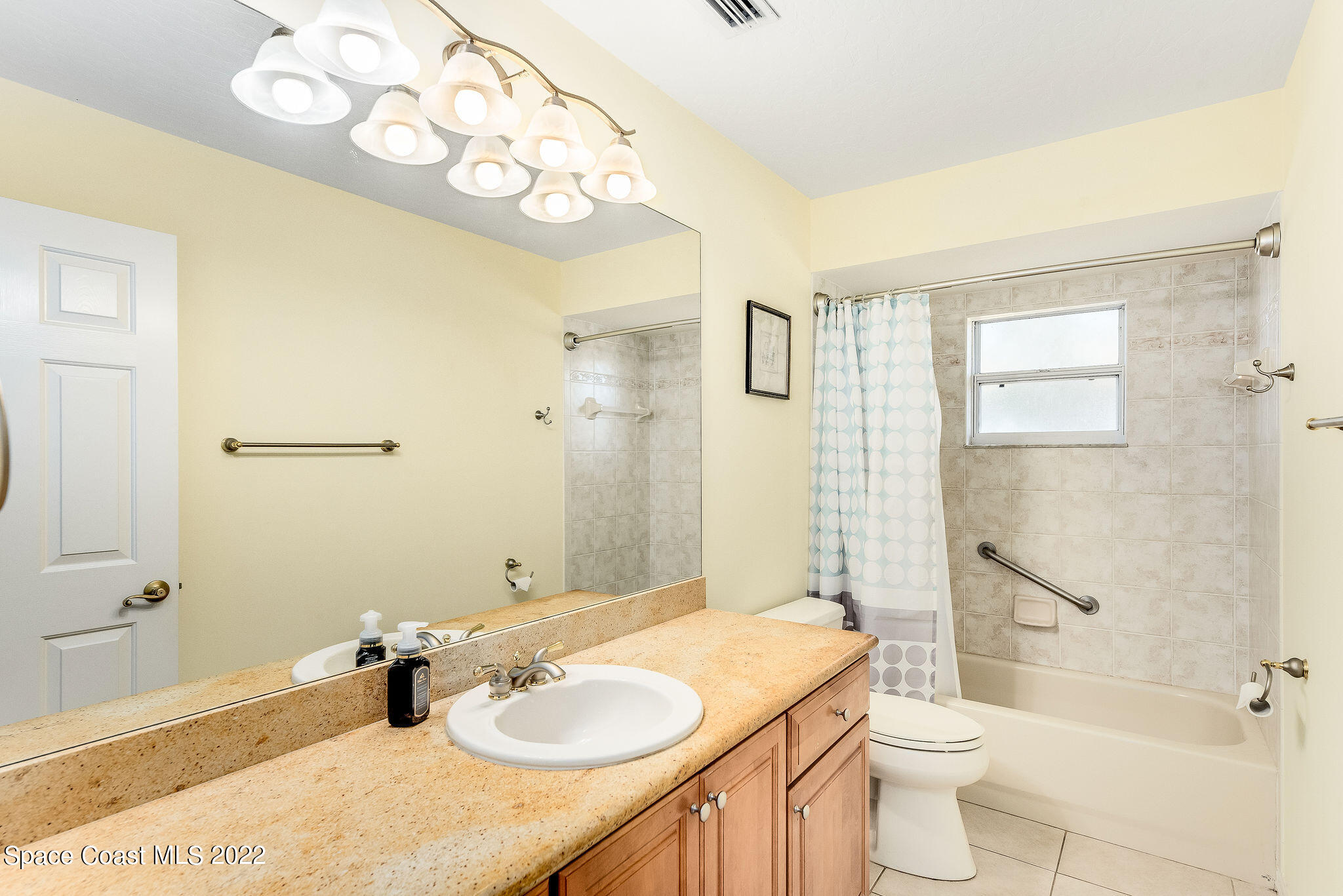 1566 Eagles Circle Sebastian, FL 32958 - Photo 40 of 59 a bathroom with a granite countertop sink mirror vanity and toilet