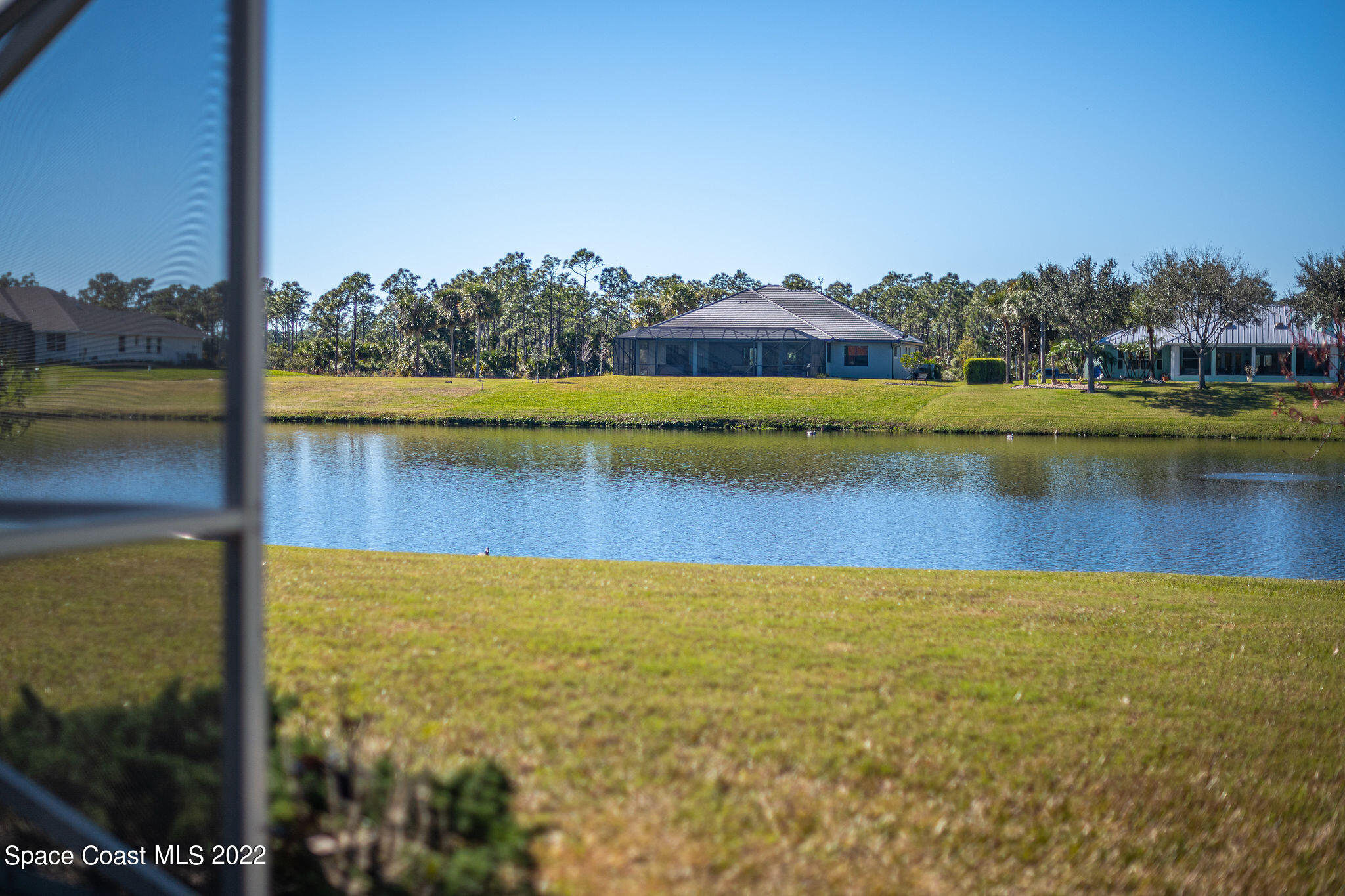 1566 Eagles Circle Sebastian, FL 32958 - Photo 54 of 59 a view of a lake with a big yard