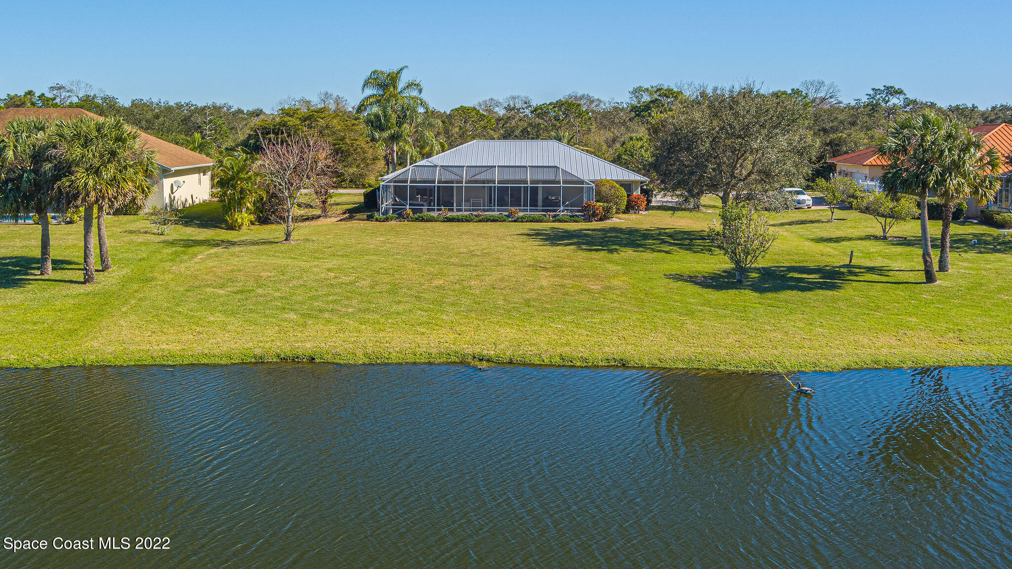 1566 Eagles Circle Sebastian, FL 32958 - Photo 58 of 59 a view of a lake with a house in the background