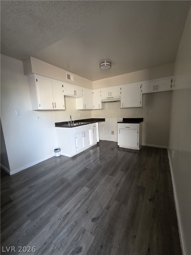 1075 East Desert Inn Road, Unit 5 Las Vegas, NV 89109 - Photo 3 of 12 A functional kitchen boasts ample cabinetry and sleek, durable flooring for everyday living.