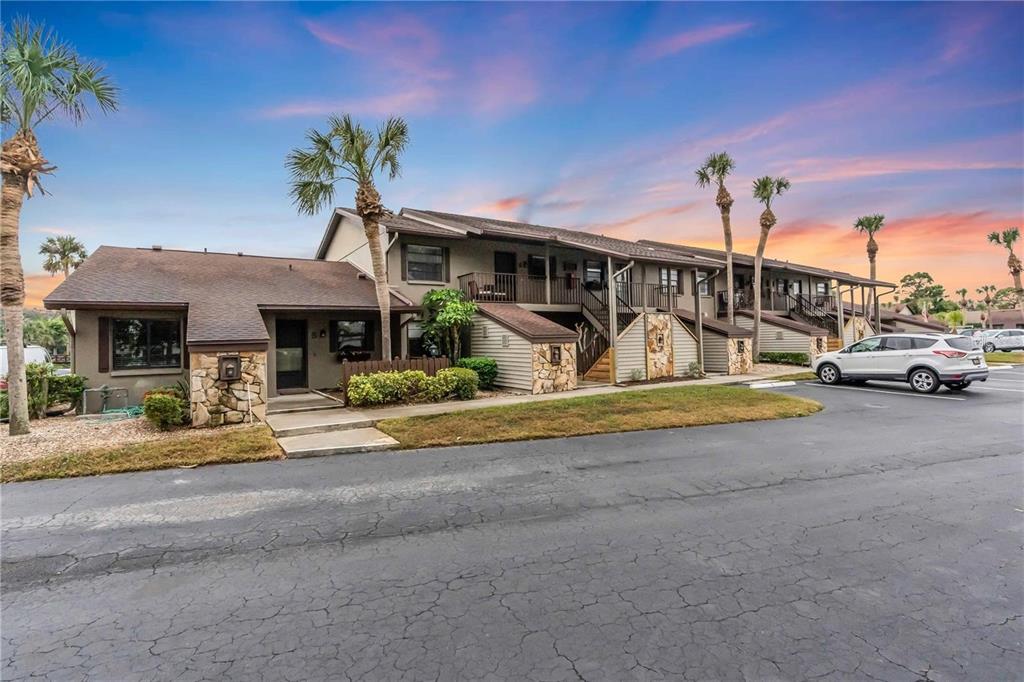 927 Capri Isles Boulevard, Unit 7 Venice, FL 34292 - Photo 1 of 1 a front view of a house with garden and parking