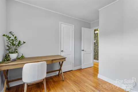 a view of a room that has a table and chair in it