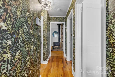 a view of a hallway with wooden floor and a hallway
