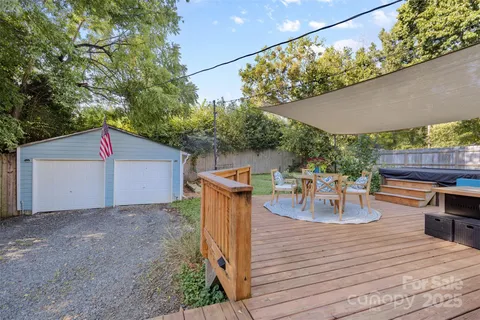 a view of a patio with table and chairs potted plants with wooden floor