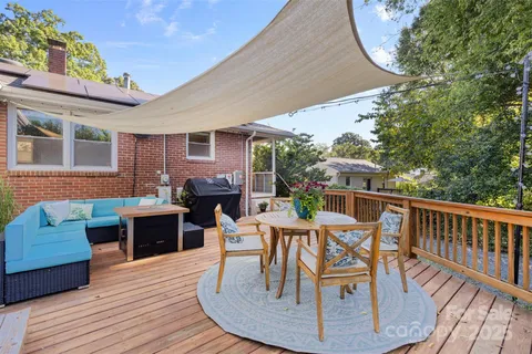 a view of a house with backyard sitting area and garden