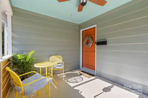 a table with chairs and a potted plant