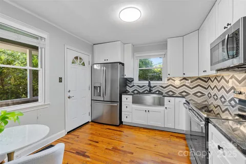 a kitchen with stainless steel appliances a stove a sink and a refrigerator