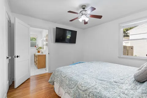 a bedroom with a bed and a flat screen tv