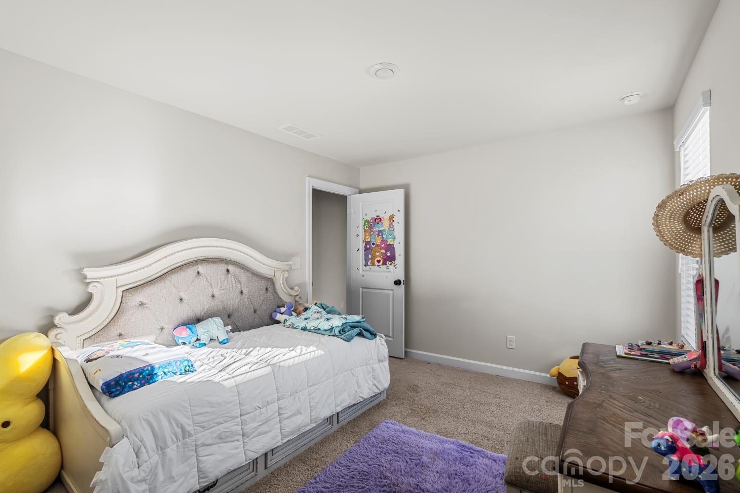 11955 Old Statesville Road Huntersville, NC 28078 - Photo 12 of 20 a bedroom with a bed and a chandelier