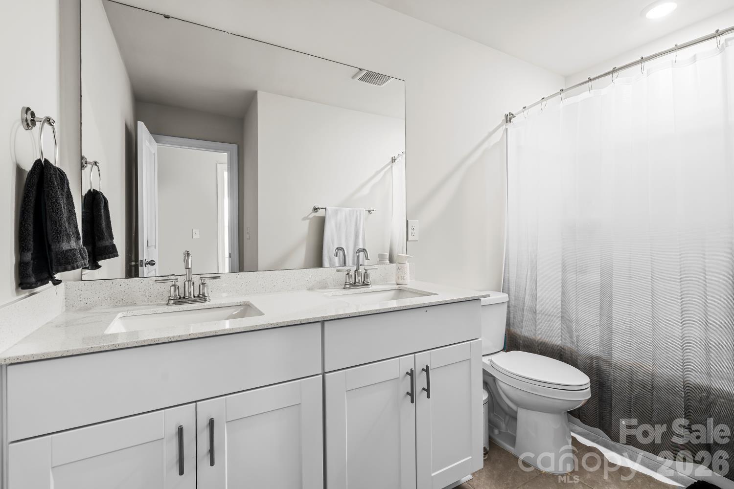 11955 Old Statesville Road Huntersville, NC 28078 - Photo 13 of 20 a bathroom with a toilet a sink and a mirror