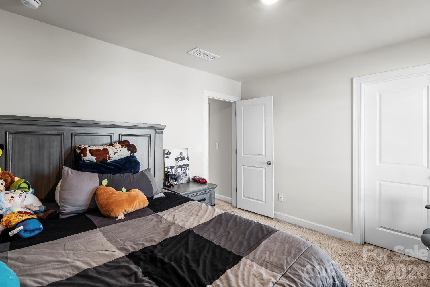 11955 Old Statesville Road Huntersville, NC 28078 - Photo 14 of 20 a bedroom with a bed and a chandelier