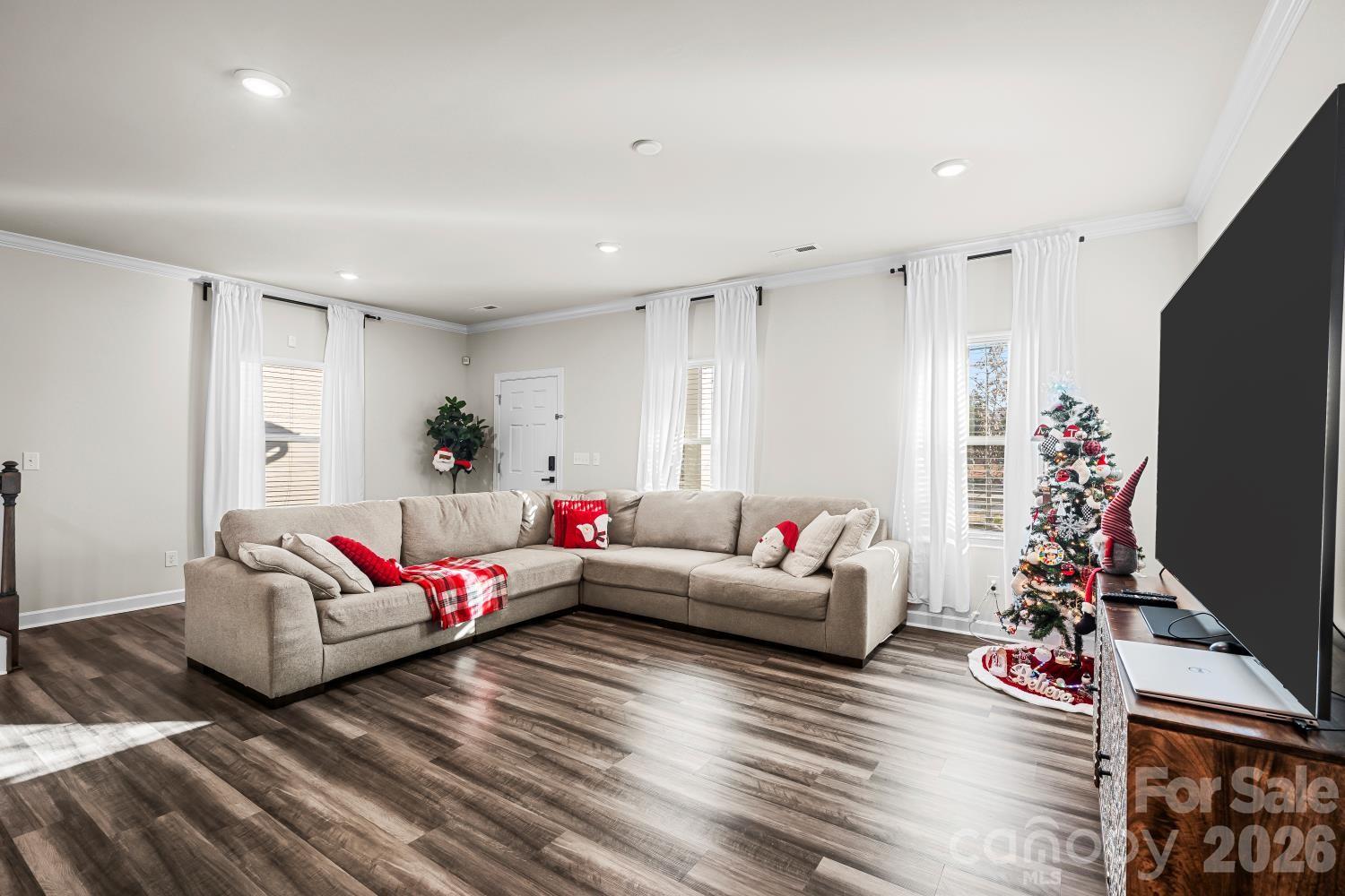 11955 Old Statesville Road Huntersville, NC 28078 - Photo 3 of 20 a living room with furniture a flat screen tv and a couch