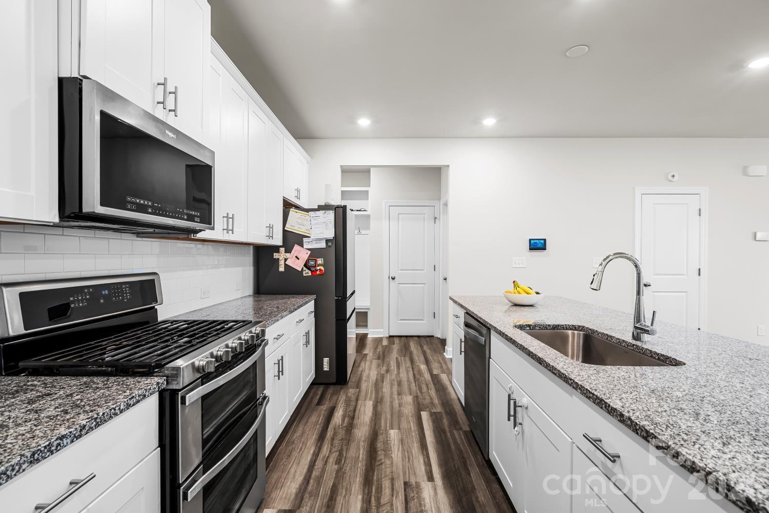 11955 Old Statesville Road Huntersville, NC 28078 - Photo 9 of 20 a kitchen with stainless steel appliances granite countertop a sink stove and refrigerator