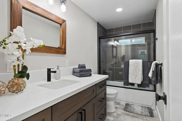 a large bed sitting in a room next to a window