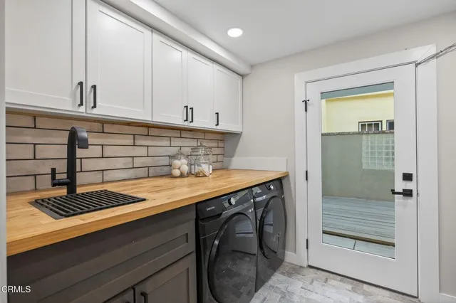 a kitchen with a sink stainless steel appliances and cabinets
