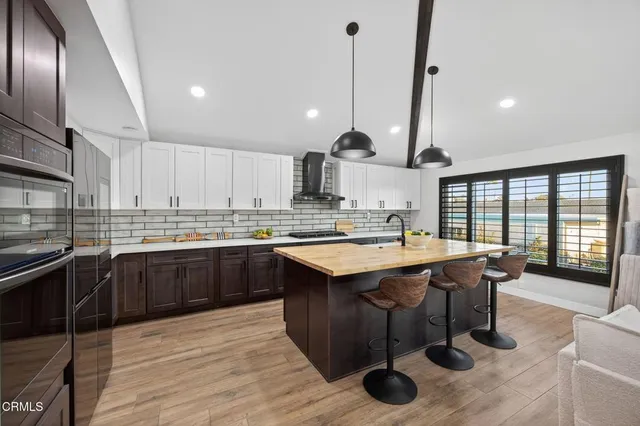 a kitchen with stainless steel appliances granite countertop a sink and stove