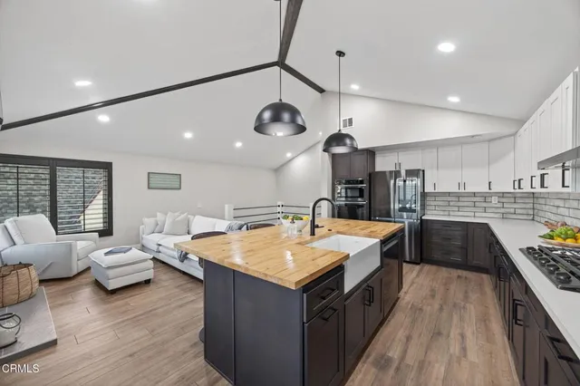 a living room with furniture fireplace and flat screen tv