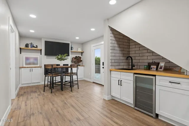 a dining room with furniture and wooden floor