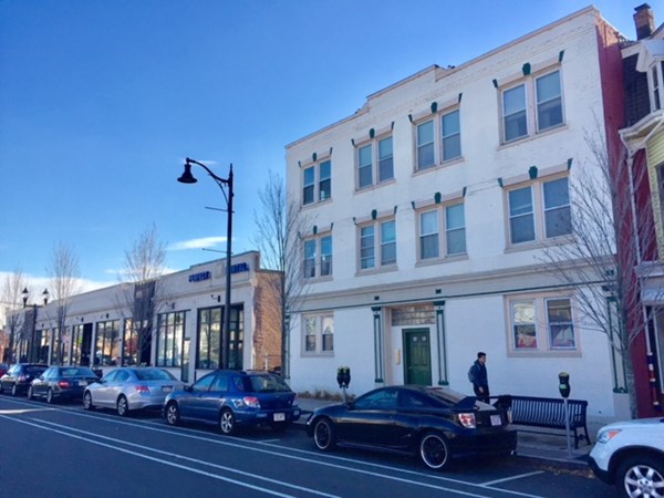 136 Broadway, Unit 3 Somerville, MA 02145 - Photo 2 of 11 a large building with multiple windows