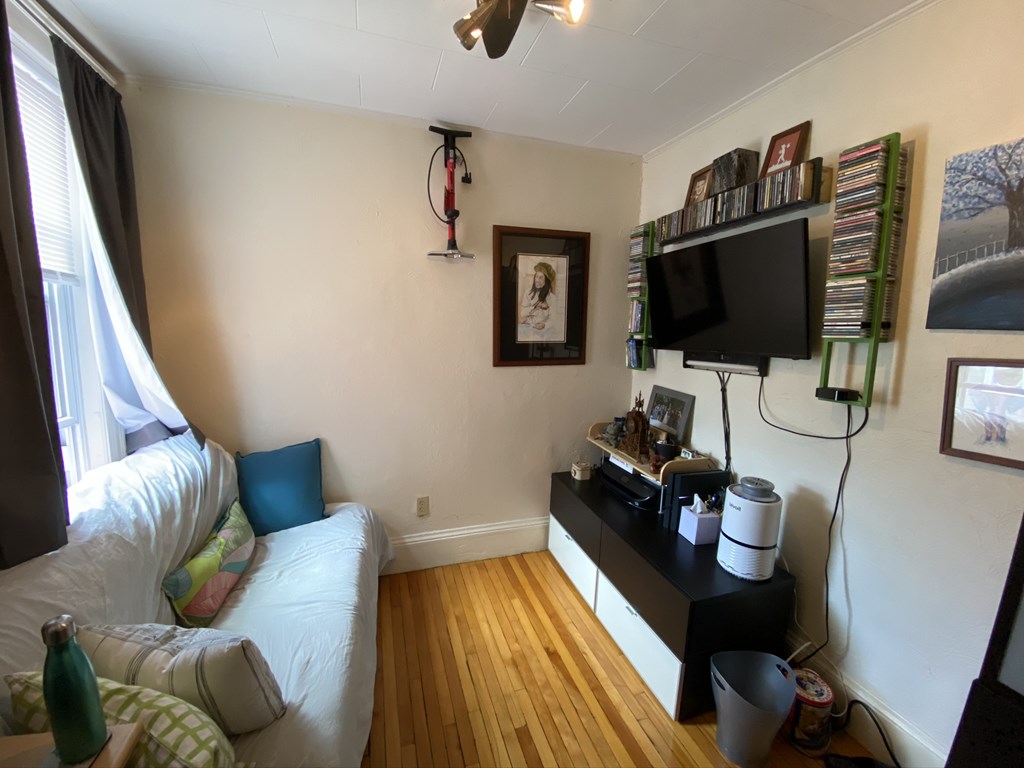 136 Broadway, Unit 3 Somerville, MA 02145 - Photo 6 of 11 a living room with furniture and a flat screen tv
