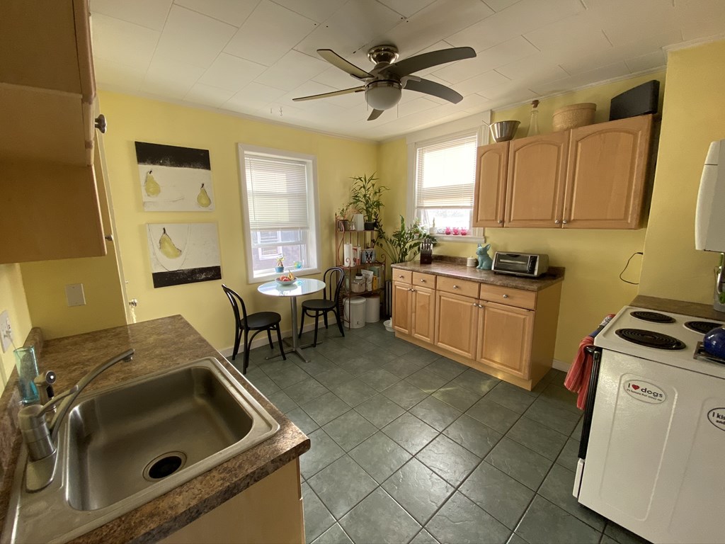 136 Broadway, Unit 3 Somerville, MA 02145 - Photo 9 of 11 a kitchen with a sink appliances and cabinets